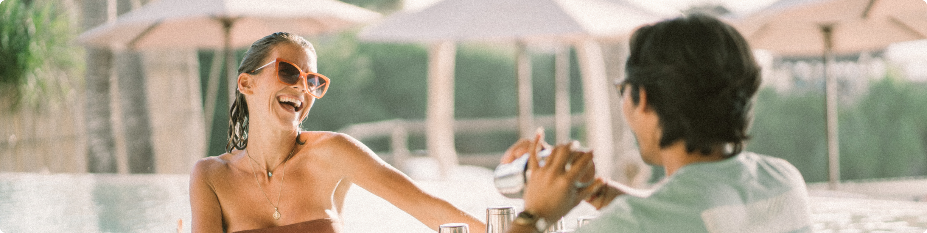 a person pouring a drink into a cup